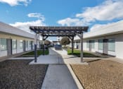 Thumbnail 11 of 17 - a courtyard with awnings and a bench in the middle