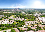 Thumbnail 19 of 72 - an aerial view of a city with a city skyline in the distance at Radius on Grove, Austin, Texas