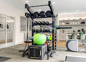 Thumbnail 57 of 72 - a home gym with a green ball in the middle at Radius on Grove, Austin, 78741