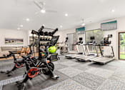 Thumbnail 15 of 72 - a gym with exercise bikes and a wall with graffiti at Radius on Grove, Austin, TX