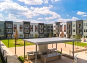 Thumbnail 58 of 65 - a rendering of an apartment building with multiple windows and a courtyard at Birdie on Woodland Greens, Austin