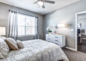 Thumbnail 3 of 37 - a bedroom with a bed and a ceiling fan at Republic at Alamo Heights, Texas, 78209