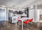 Thumbnail 2 of 37 - a dining area with a table and chairs and a kitchen in the background at Republic at Alamo Heights, Texas, 78209