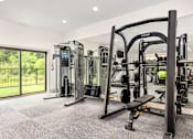 Thumbnail 63 of 72 - a gym with exercise equipment and a glass sliding door at Radius on Grove, Austin, TX, 78741