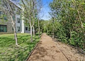 Thumbnail 52 of 72 - a dirt path with trees and buildings on the side of it at Radius on Grove, Austin, 78741