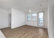 Thumbnail 49 of 65 - a living room with a hard wood floor and white walls at Birdie on Woodland Greens, Austin