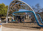 Thumbnail 6 of 30 - Modern playground with curved climbing structure at THE'68 Apartments, San Antonio, TX 78205