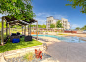 Thumbnail 49 of 72 - a swimming pool with a pavilion and a building in the background at Radius on Grove, Austin, TX