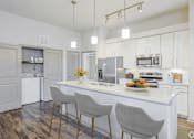 Thumbnail 2 of 72 - A kitchen with a white countertop and grey chairsat Radius on Grove, Austin
