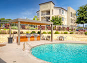 Thumbnail 58 of 72 - a swimming pool with a building in the background at Radius on Grove, Austin, Texas