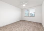 Thumbnail 38 of 65 - an empty room with a window and a ceiling fan at Birdie on Woodland Greens, Texas