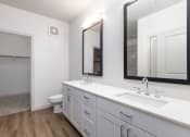 Thumbnail 40 of 65 - a bathroom with a sink and a mirror and a toilet at Birdie on Woodland Greens, Austin, 78726