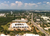 Thumbnail 65 of 65 - an aerial view of a large building in the middle of a city at Birdie on Woodland Greens, Austin, TX