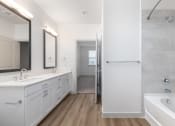 Thumbnail 35 of 65 - a bathroom with two sinks and a tub and a shower at Birdie on Woodland Greens, Austin, 78726