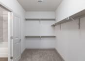 Thumbnail 37 of 65 - a spacious bathroom with a shower and a door to a closet at Birdie on Woodland Greens, Texas
