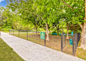Thumbnail 16 of 72 - a park with a chain link fence and a sign for a dog park at Radius on Grove, Austin, TX, 78741