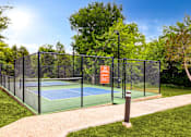 Thumbnail 46 of 72 - a tennis court with a fence around it on a sunny day at Radius on Grove, Texas, 78741