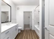 Thumbnail 47 of 65 - a bathroom with white cabinets and a shower and a sink and a toilet at Birdie on Woodland Greens, Austin, Texas