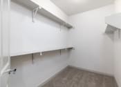 Thumbnail 45 of 65 - an empty room with white walls and shelves and a closet at Birdie on Woodland Greens, Texas