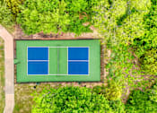Thumbnail 6 of 72 - a tennis court on the grass with trees around it at Radius on Grove, Austin, TX