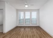 Thumbnail 50 of 65 - an empty living room with white walls and a ceiling fan at Birdie on Woodland Greens, Austin, Texas