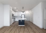 Thumbnail 48 of 65 - a renovated kitchen with white cabinets and a white counter top in a new home at Birdie on Woodland Greens, Austin