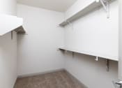Thumbnail 51 of 65 - an empty room with white walls and white shelves and hooks on the wall at Birdie on Woodland Greens, Austin, 78726