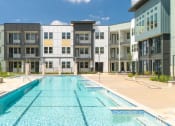Thumbnail 54 of 65 - a swimming pool in front of a building at Birdie on Woodland Greens, Austin