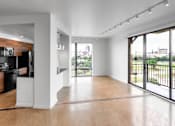 Thumbnail 20 of 30 - Open living room with balcony and city views at THE'68 Apartments, San Antonio, 78205