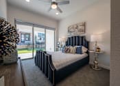 Thumbnail 20 of 41 - A bedroom with a large bed and a ceiling fan.