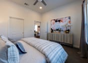 Thumbnail 26 of 41 - A bedroom with two beds and a ceiling fan.