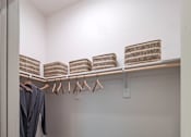 Thumbnail 37 of 41 - A laundry room with a washer and dryer, a basket, and clothes hanging up.