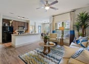 Thumbnail 58 of 59 - a living room and kitchen area with a ceiling fan at Alvista Round Rock, Round Rock, TX, 78664