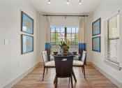 Thumbnail 46 of 59 - a dining room with a table and chairs in front of a window with blinds at Alvista Round Rock, Round Rock, TX, 78664