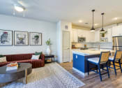 Thumbnail 1 of 65 - a living area with a kitchen and a dining table at Birdie on Woodland Greens, Austin, Texas