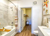 Thumbnail 9 of 65 - a bathroom with a shower and a toilet and a sink at Birdie on Woodland Greens, Austin, Texas