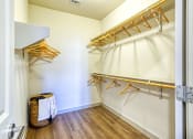 Thumbnail 24 of 65 - a walk in closet with hanging racks and a basket on the floor at Birdie on Woodland Greens, Texas