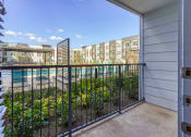 Thumbnail 62 of 65 - the view of the pool from the balcony of an apartment building at Birdie on Woodland Greens, Austin, Texas