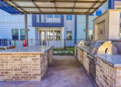 Thumbnail 18 of 65 - a kitchen area with two counters and a building at Birdie on Woodland Greens, Austin, 78726