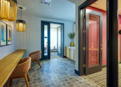 Thumbnail 14 of 65 - a dining room with a table and chairs and a door to a bathroom at Birdie on Woodland Greens, Austin