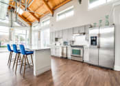 Thumbnail 18 of 27 - a kitchen with white cabinets and stainless steel appliances at The Landings at Brooks City-Base, San Antonio, Texas