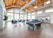 Thumbnail 17 of 27 - a large room with a pool table and chairs at The Landings at Brooks City-Base, Texas