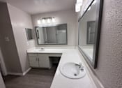 Thumbnail 7 of 17 - A bathroom with a sink and mirror.