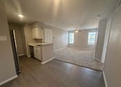 Thumbnail 6 of 17 - A kitchen with a refrigerator, sink, and cabinets.