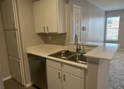 Thumbnail 15 of 17 - A kitchen with white cabinets and a stainless steel dishwasher.