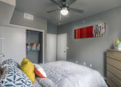 Thumbnail 18 of 37 - a bedroom with a large bed and a ceiling fan at Republic at Alamo Heights, San Antonio