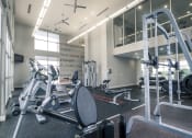 Thumbnail 13 of 37 - a gym with weights and other exercise equipment at Republic at Alamo Heights, San Antonio, TX