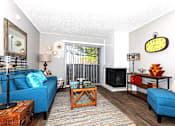 Thumbnail 14 of 16 - A living room with a blue couch, a wooden coffee table, and a large clock on the wall.