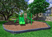 Thumbnail 3 of 16 - A green playground in a residential area.