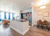 Thumbnail 11 of 27 - our apartments offer a living room with a fireplace and a dining area at The Landings at Brooks City-Base, Texas